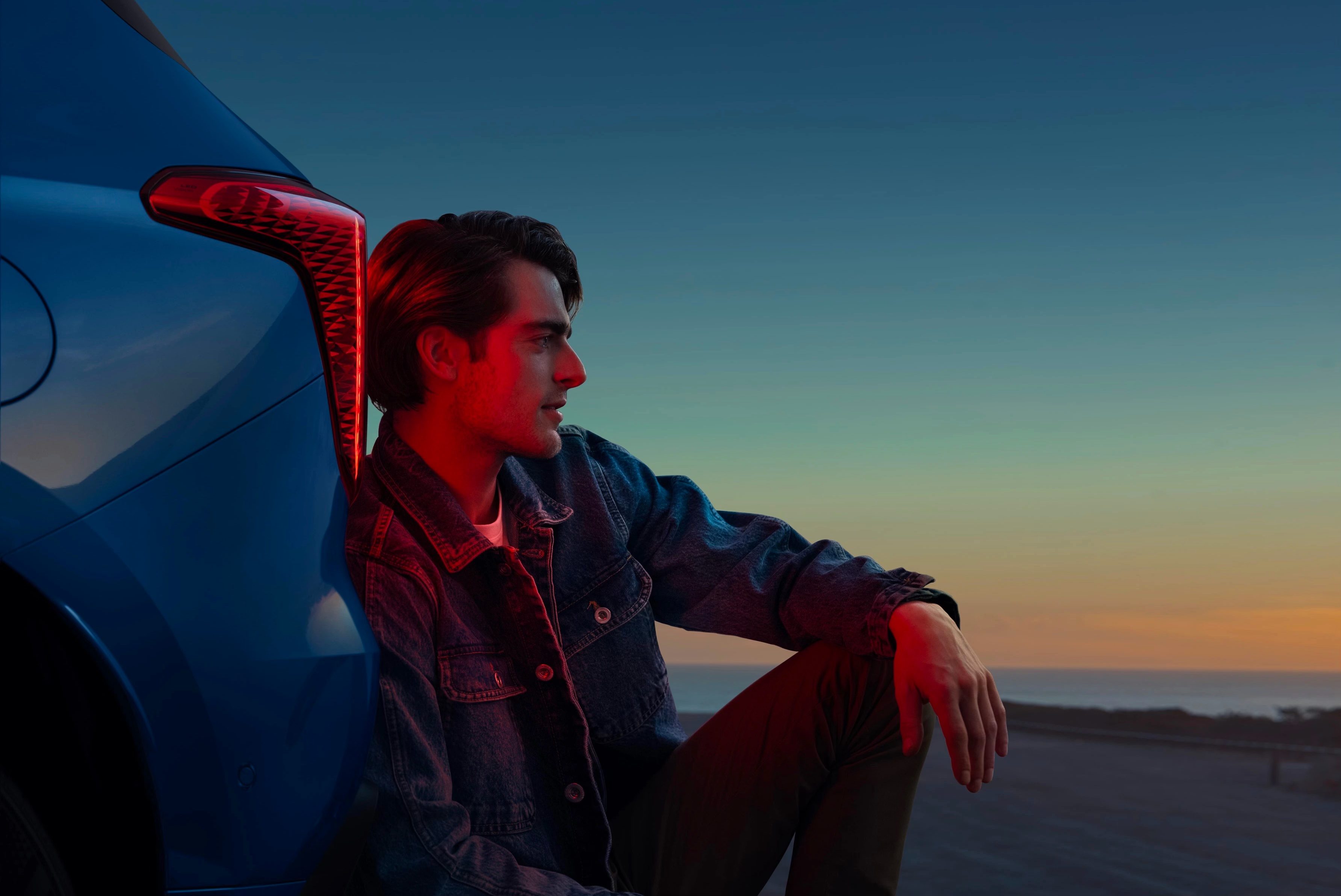 HAVAL F7 campaign image with a driver beside a blue SUV at sunset